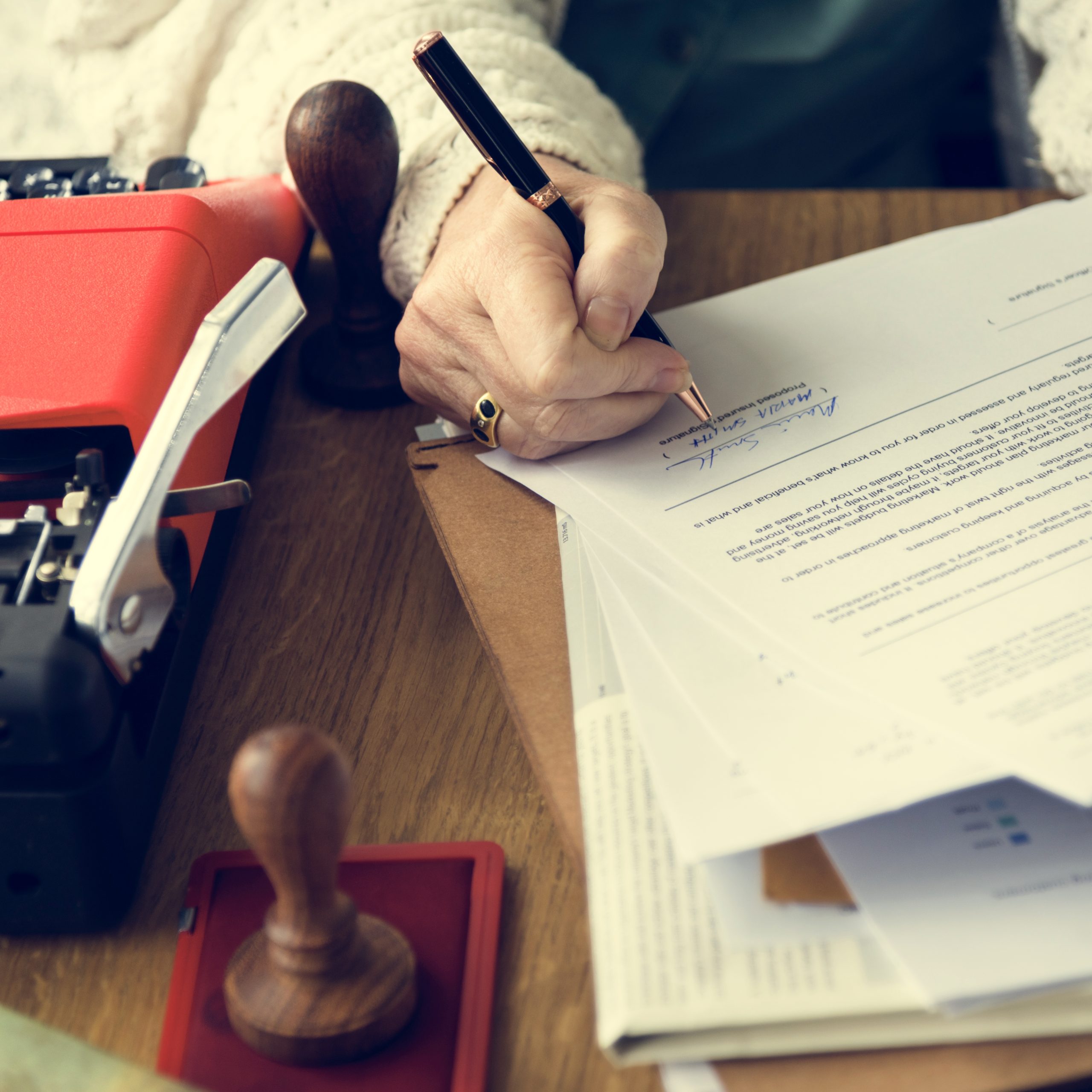 Documentary collection paperwork being signed and stamped for trade finance payment verification